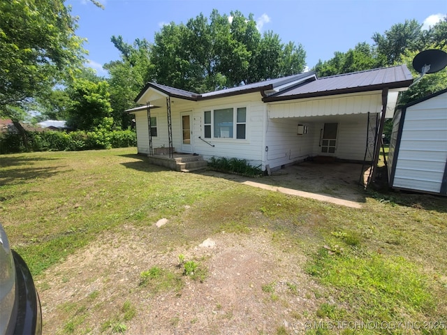 1763 Bryan St, Westville, OK 74965 - view of front of home featuring a front yard, an attached carport, and a metal roof