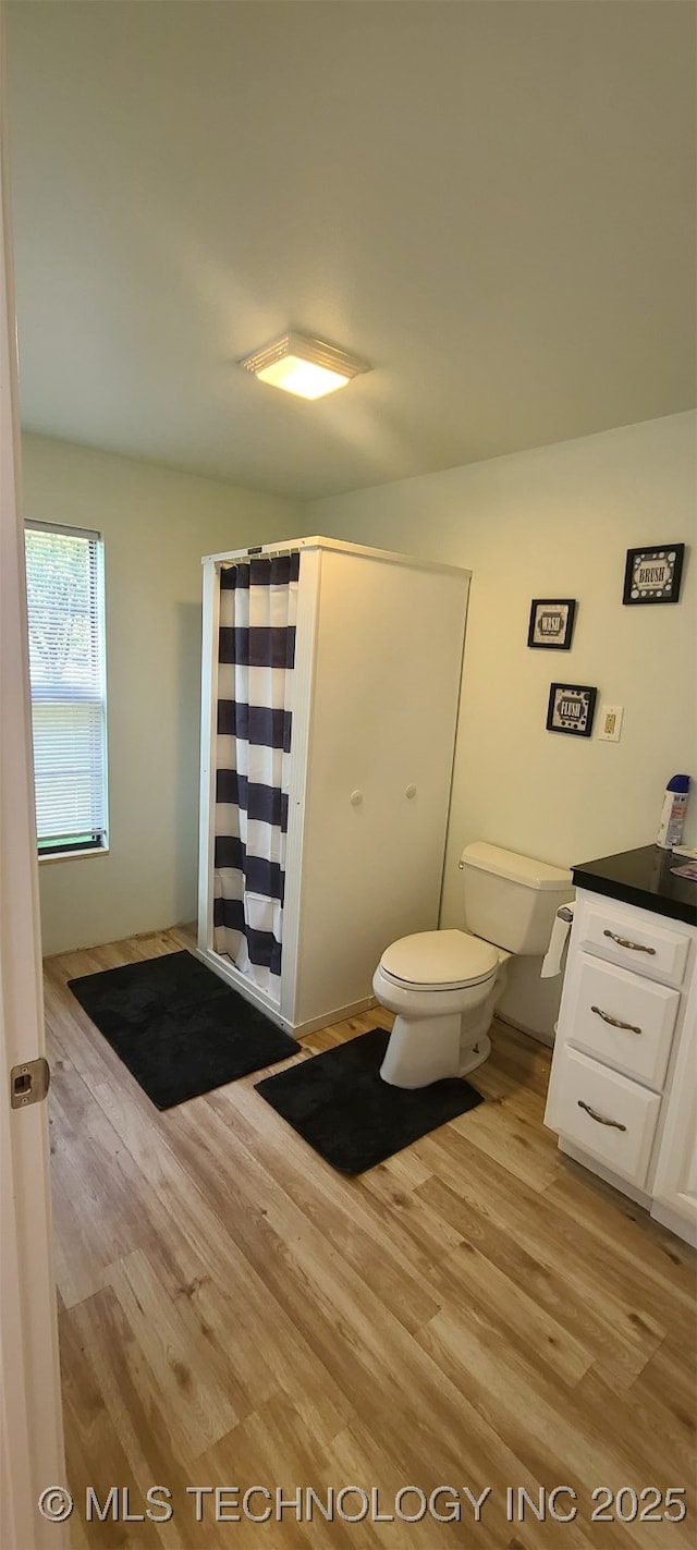 1763 Bryan St, Westville, OK 74965 - bathroom with wood finished floors, vanity, and a shower with shower curtain