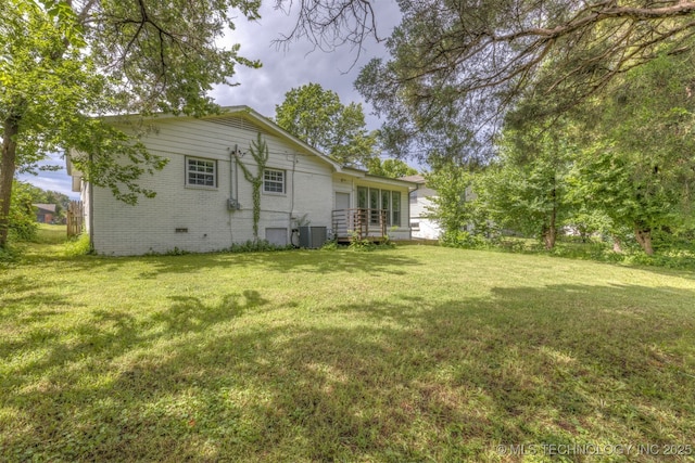 5951 E 25th Pl S, Tulsa, OK 74114 - rear view of house featuring a lawn and brick siding