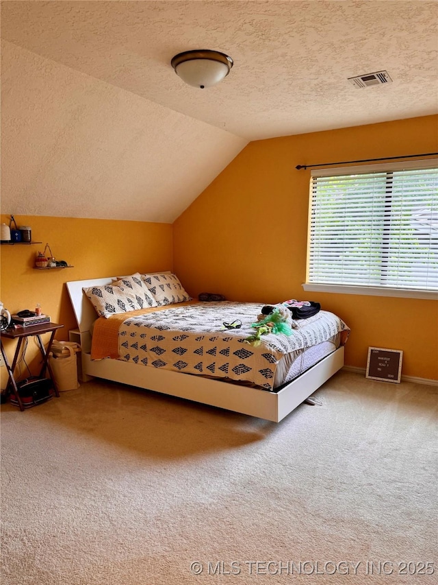 8448 S Florence Ave, Tulsa, OK 74137 - bedroom featuring a textured ceiling, carpet floors, and vaulted ceiling