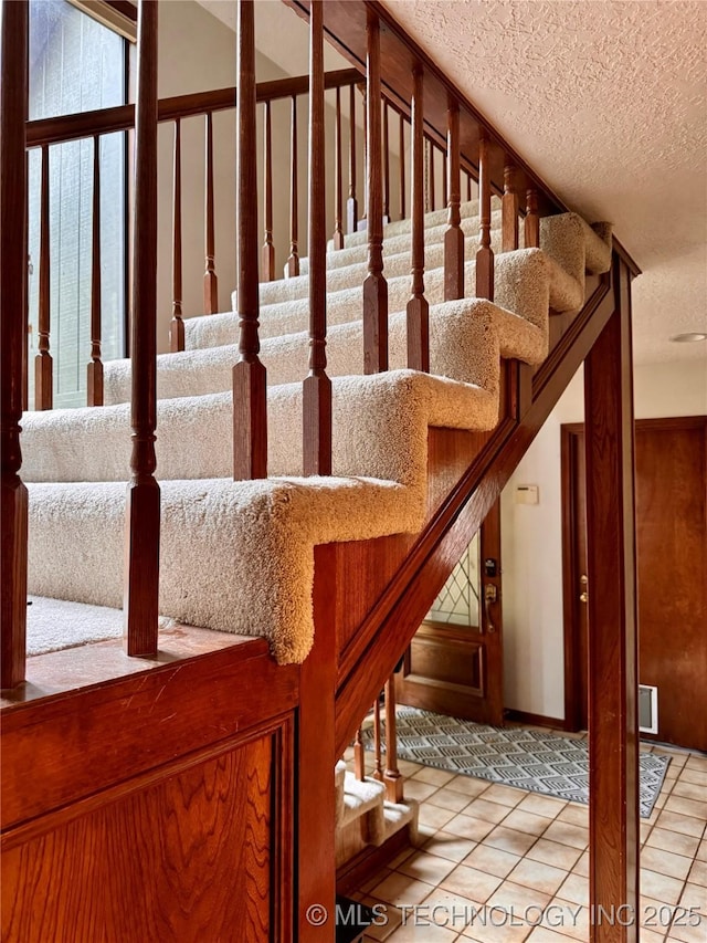 8448 S Florence Ave, Tulsa, OK 74137 - stairway with a textured ceiling and tile patterned flooring