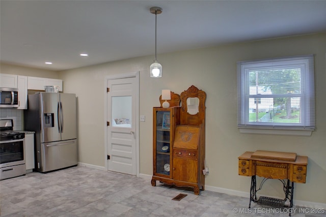 4545 S 30th W Ave, Tulsa, OK 74107 - kitchen with stainless steel appliances, white cabinetry, decorative light fixtures, recessed lighting, and decorative backsplash