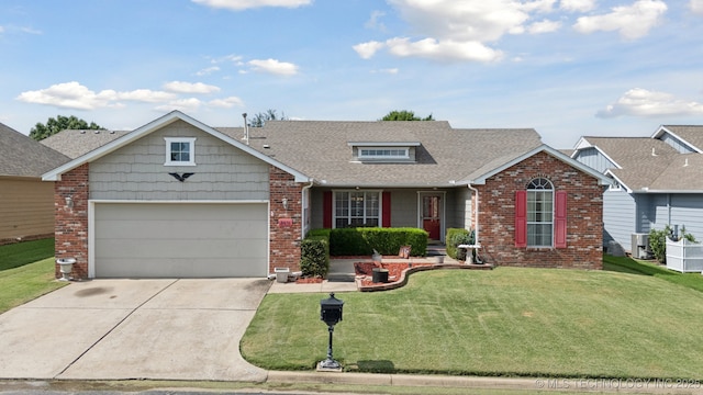 8931 E 62nd Pl, Tulsa, OK 74133 - view of front of house with brick siding, an attached garage, concrete driveway, and a front yard