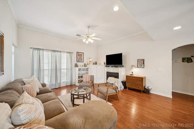 8931 E 62nd Pl, Tulsa, OK 74133 - living area featuring arched walkways, ceiling fan, wood finished floors, recessed lighting, and ornamental molding