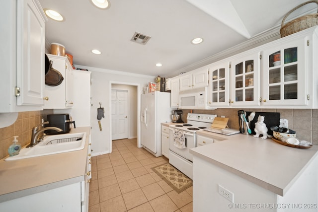 8931 E 62nd Pl, Tulsa, OK 74133 - kitchen with white appliances, crown molding, decorative backsplash, white cabinetry, and glass insert cabinets