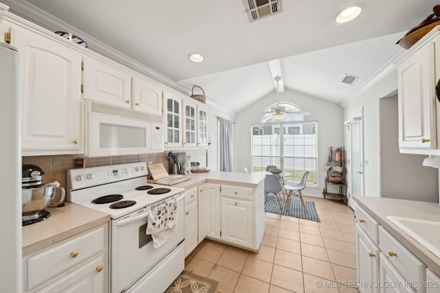 8931 E 62nd Pl, Tulsa, OK 74133 - kitchen featuring white appliances, lofted ceiling, light countertops, white cabinetry, and tasteful backsplash
