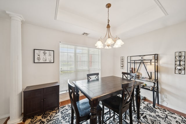 8931 E 62nd Pl, Tulsa, OK 74133 - dining area with ornate columns, a raised ceiling, a chandelier, and light wood-type flooring