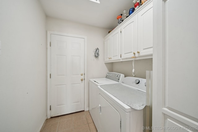 8931 E 62nd Pl, Tulsa, OK 74133 - washroom featuring washer and dryer, cabinet space, and light tile patterned floors