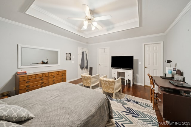 8931 E 62nd Pl, Tulsa, OK 74133 - bedroom with a tray ceiling, wood finished floors, crown molding, and a ceiling fan