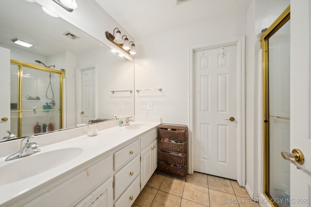 8931 E 62nd Pl, Tulsa, OK 74133 - bathroom with double vanity, a shower stall, and tile patterned floors