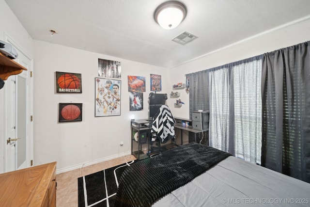 8931 E 62nd Pl, Tulsa, OK 74133 - bedroom with tile patterned flooring and an office area