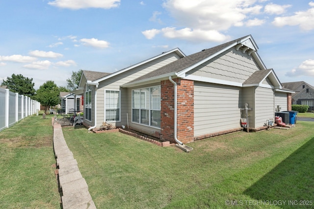 8931 E 62nd Pl, Tulsa, OK 74133 - view of side of home featuring brick siding and roof with shingles