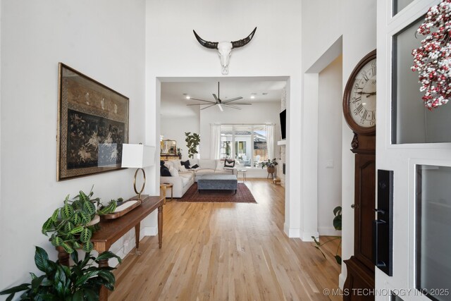 6103 W Charleston Pl, Broken Arrow, OK 74011 - entrance foyer with light wood-style flooring, a towering ceiling, and a ceiling fan
