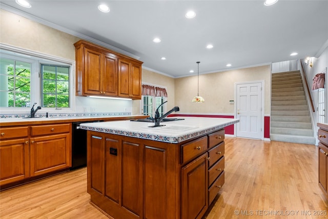 8710 S Vandalia Ave, Tulsa, OK 74137 - kitchen featuring black dishwasher, ornamental molding, light wood finished floors, a kitchen island with sink, and brown cabinets