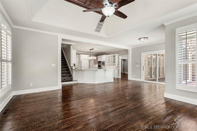 10150 S Maplewood Ave, Tulsa, OK 74137 - unfurnished living room with stairs, dark wood-style floors, ceiling fan, a chandelier, and ornamental molding