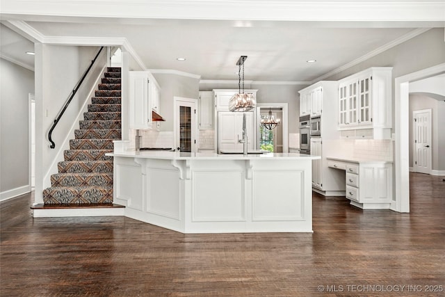 10150 S Maplewood Ave, Tulsa, OK 74137 - kitchen with a peninsula, white cabinets, light countertops, a chandelier, and recessed lighting