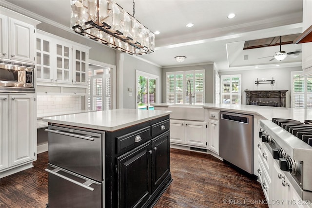 10150 S Maplewood Ave, Tulsa, OK 74137 - kitchen featuring stainless steel appliances, dark cabinetry, white cabinetry, dark wood-type flooring, and crown molding