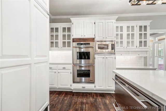 10150 S Maplewood Ave, Tulsa, OK 74137 - kitchen featuring appliances with stainless steel finishes, light countertops, white cabinetry, and crown molding