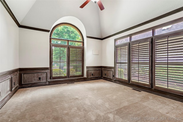 10150 S Maplewood Ave, Tulsa, OK 74137 - carpeted spare room with a wainscoted wall, ceiling fan, crown molding, a decorative wall, and high vaulted ceiling