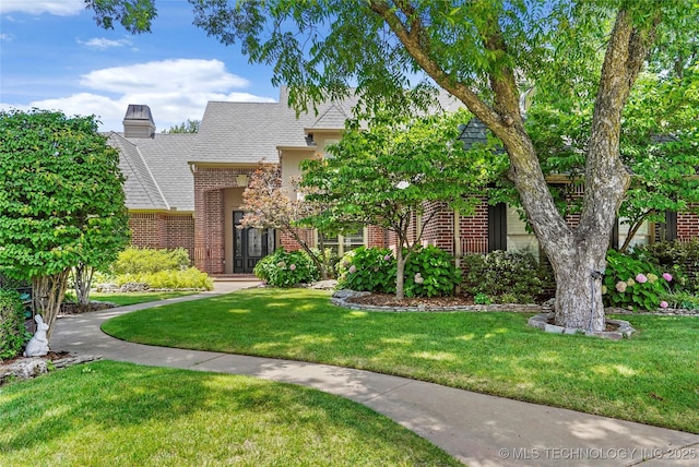 10150 S Maplewood Ave, Tulsa, OK 74137 - view of front of house featuring brick siding, a front lawn, and roof with shingles