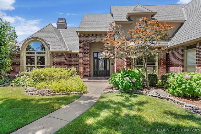 10150 S Maplewood Ave, Tulsa, OK 74137 - view of front facade with brick siding, a front lawn, and a chimney
