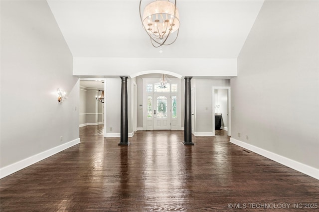 10150 S Maplewood Ave, Tulsa, OK 74137 - foyer entrance with ornate columns, a chandelier, arched walkways, wood finished floors, and vaulted ceiling