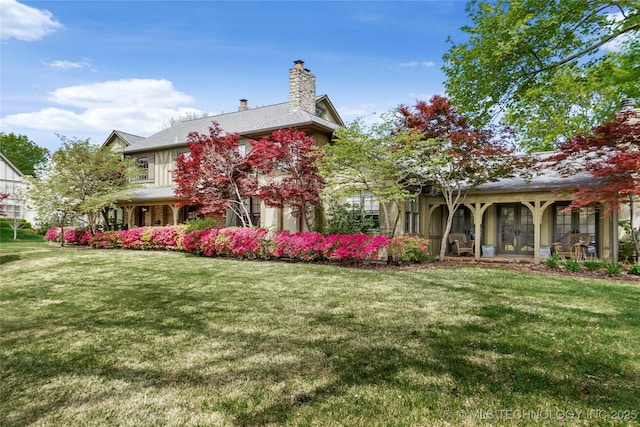 1111 E 24th Pl, Tulsa, OK 74114 - rear view of house featuring french doors, a lawn, a chimney, and covered porch