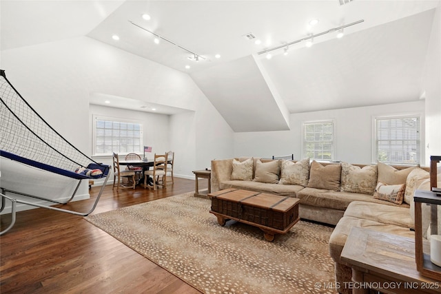 1111 E 24th Pl, Tulsa, OK 74114 - living area with lofted ceiling, wood finished floors, plenty of natural light, and rail lighting
