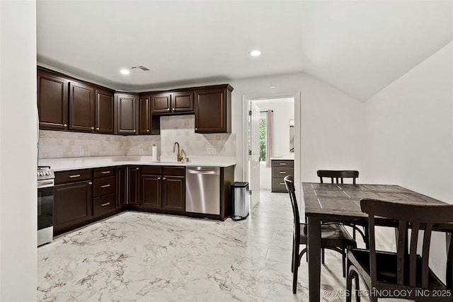 1111 E 24th Pl, Tulsa, OK 74114 - kitchen with stainless steel appliances, light countertops, dark brown cabinetry, backsplash, and lofted ceiling