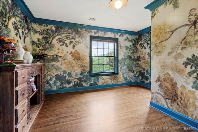 1111 E 24th Pl, Tulsa, OK 74114 - spare room featuring wood finished floors, ornamental molding, and wallpapered walls