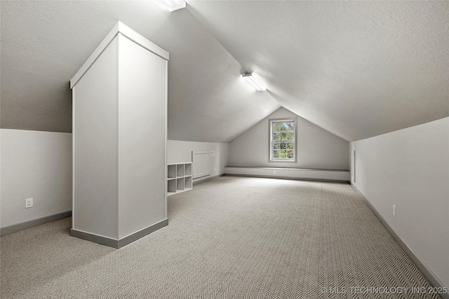 1111 E 24th Pl, Tulsa, OK 74114 - additional living space featuring a baseboard radiator, carpet flooring, lofted ceiling, and a textured ceiling