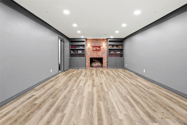 1111 E 24th Pl, Tulsa, OK 74114 - unfurnished living room with crown molding, recessed lighting, light wood finished floors, a fireplace, and built in shelves