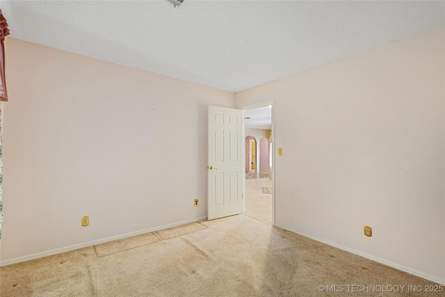 39827 Morris Creek Rd, Howe, OK 74940 - carpeted empty room with arched walkways and baseboards