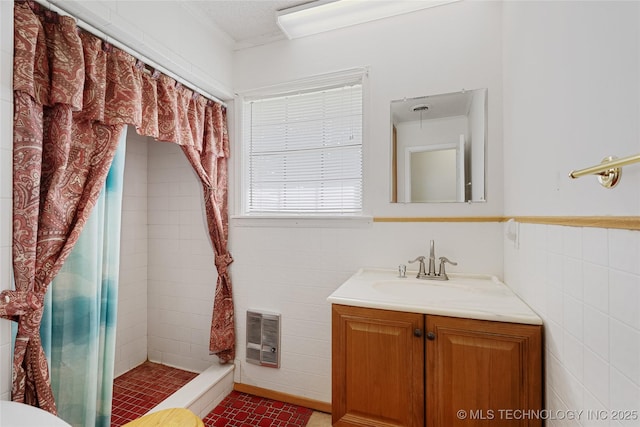 39827 Morris Creek Rd, Howe, OK 74940 - bathroom with a stall shower, heating unit, vanity, and tile walls