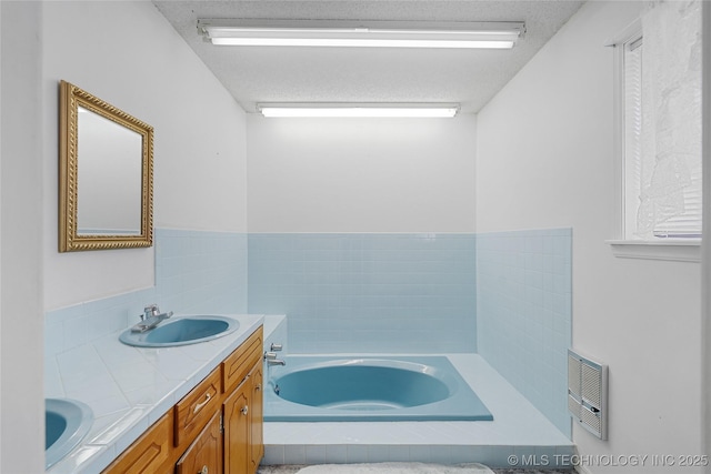 39827 Morris Creek Rd, Howe, OK 74940 - full bathroom with a garden tub, double vanity, heating unit, and a textured ceiling