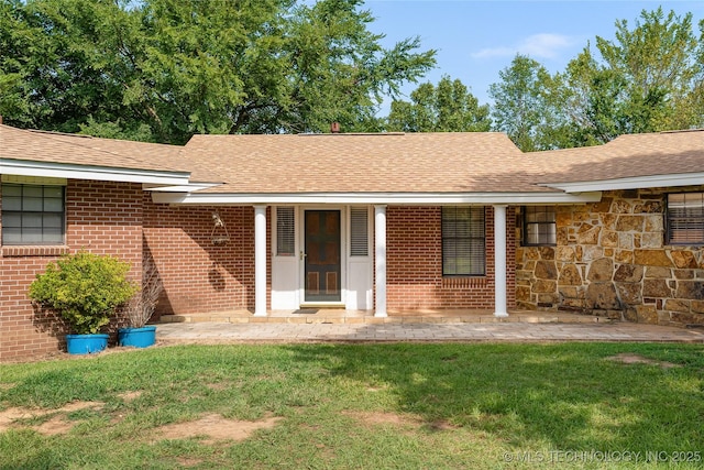 39827 Morris Creek Rd, Howe, OK 74940 - property entrance featuring a yard, brick siding, a shingled roof, and stone siding