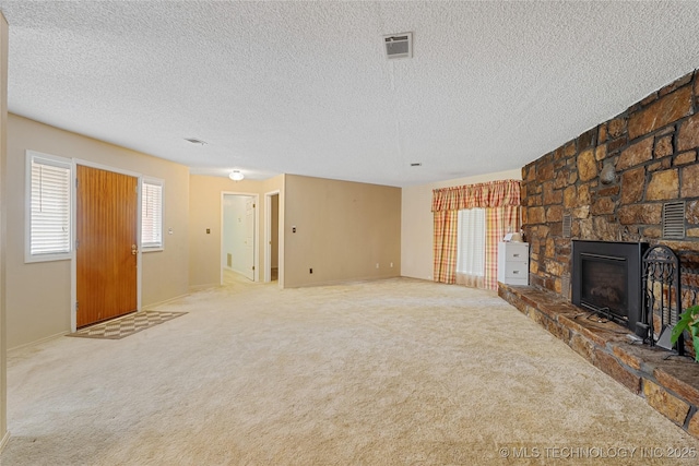 39827 Morris Creek Rd, Howe, OK 74940 - unfurnished living room featuring a textured ceiling, a stone fireplace, and carpet flooring