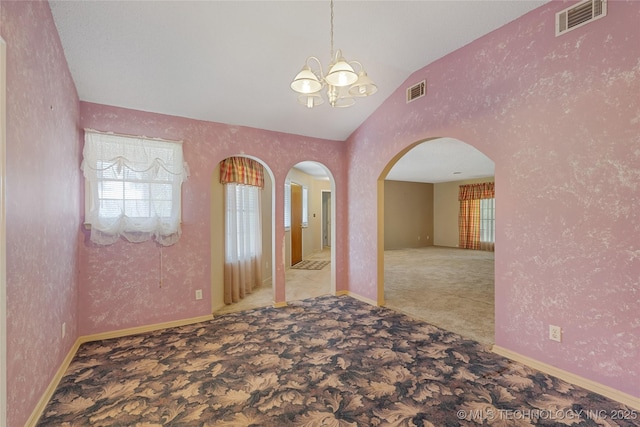 39827 Morris Creek Rd, Howe, OK 74940 - spare room featuring a chandelier, healthy amount of natural light, carpet floors, arched walkways, and high vaulted ceiling
