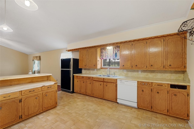 39827 Morris Creek Rd, Howe, OK 74940 - kitchen with white dishwasher, freestanding refrigerator, light countertops, decorative backsplash, and brown cabinets
