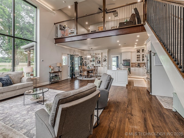 20853 S 81st Ave W, Mounds, OK 74047 - living area with a towering ceiling, dark wood-style floors, and stairway