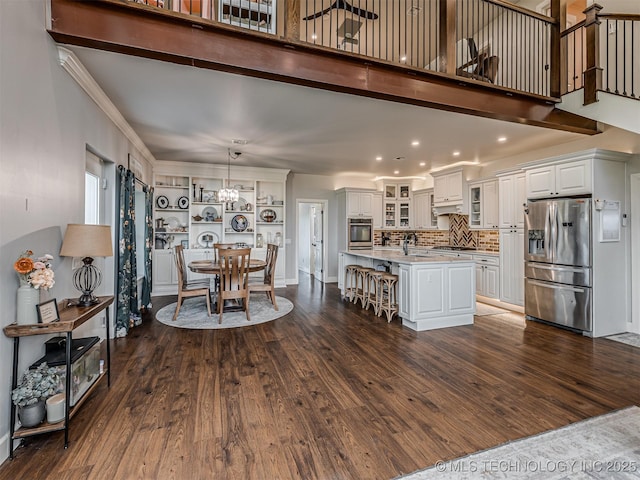 20853 S 81st Ave W, Mounds, OK 74047 - dining space featuring dark wood-type flooring, a chandelier, a high ceiling, recessed lighting, and ornamental molding