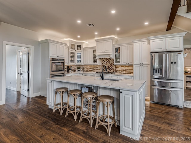 20853 S 81st Ave W, Mounds, OK 74047 - kitchen with stainless steel appliances, tasteful backsplash, a center island with sink, dark wood finished floors, and recessed lighting