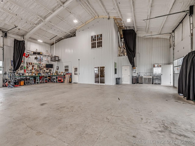 20853 S 81st Ave W, Mounds, OK 74047 - garage with metal wall, a workshop area, and stainless steel fridge