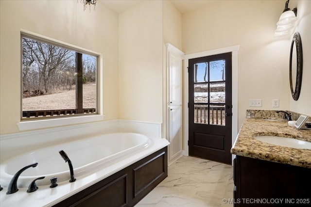 16511 S 4230th Rd, Claremore, OK 74017 - full bathroom featuring double vanity, marble look tiles, and a garden tub