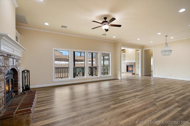 16511 S 4230th Rd, Claremore, OK 74017 - unfurnished living room featuring a stone fireplace, wood finished floors, ceiling fan, crown molding, and recessed lighting