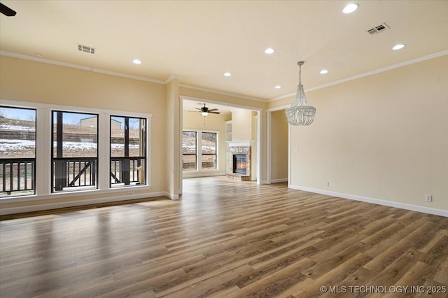 16511 S 4230th Rd, Claremore, OK 74017 - unfurnished living room featuring ceiling fan, wood finished floors, ornamental molding, a fireplace, and recessed lighting