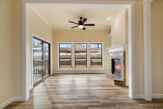 16511 S 4230th Rd, Claremore, OK 74017 - unfurnished living room featuring ornamental molding, ceiling fan, a glass covered fireplace, and light wood-style floors