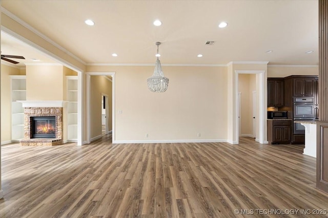 16511 S 4230th Rd, Claremore, OK 74017 - unfurnished living room featuring ornamental molding, light wood-type flooring, recessed lighting, a glass covered fireplace, and a ceiling fan