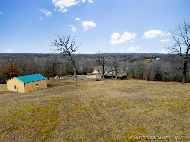 16511 S 4230th Rd, Claremore, OK 74017 - view of green lawn with a forest view and an outdoor structure
