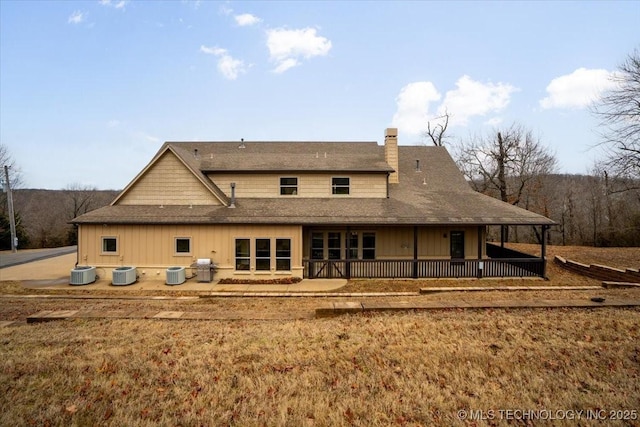16511 S 4230th Rd, Claremore, OK 74017 - rear view of house featuring a chimney, roof with shingles, and board and batten siding
